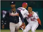  ?? ALEX BRANDON — THE ASSOCIATED PRESS ?? Washington’s Juan Soto, right, and Trea Turner celebrate behind Atlanta second baseman Ozzie Albies after Soto hit a winning single in the ninth inning in Washington.