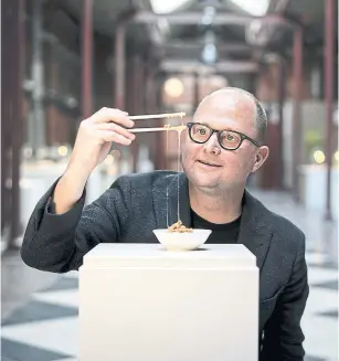  ?? MATHIAS SVOLD PHOTOS THE NEW YORK TIMES ?? Samuel West, the curator of the Disgusting Food Museum, plays with fermented soy at the museum in Malmo, Sweden. “I want people to question what they find disgusting,” West said.