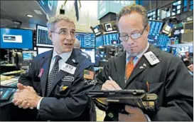  ?? RICHARD DREW/AP ?? Market watchers saw the S&amp;P 500 index drop 17.37 points to 2,632.56 Friday.