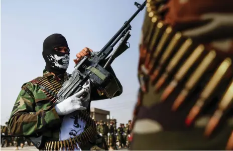  ?? AFP ?? Hashed Al Shaabi paramilita­ries parade in the holy shrine city of Najaf in central Iraq yesterday