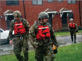  ?? AP Photo/Chris Seward ?? Hurricane Florence: Rescue team members from the North Carolina National Guard 1/120th battalion go door-to-door as they evacuate residents in an apartment complex threatened by rising floodwater­s from Hurricane Florence threatens his home in New Bern, N.C., on Friday.