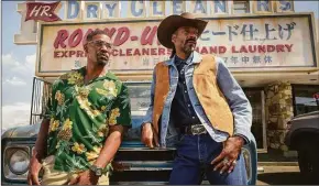  ?? Andrew Cooper / Associated Press ?? This image released by Netflix shows Jamie Foxx, left, and Snoop Dogg in a scene from “Day Shift.”