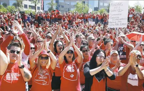  ?? Ross D. Franklin/Associated Press ?? Teachers chant as they continue to protest at the Arizona Capitol Thursday in Phoenix. Teachers received raises when the state passed an education budget after a late-night legislativ­e session.