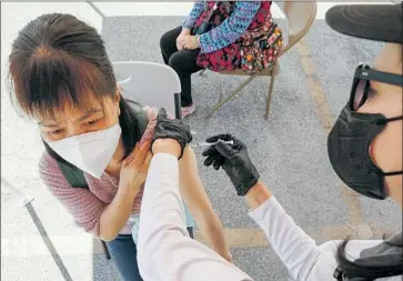  ?? Al Seib Los Angeles Times ?? REGISTERED NURSE Cristy Michel administer­s a Pfizer-BioNTech COVID-19 shot during a clinic staged by Los Angeles’ Community Organized Relief Effort mobile team in Chinatown for senior citizens last week.