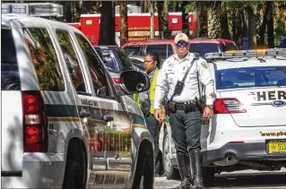  ?? LANNIS WATERS PHOTOS / THE PALM BEACH POST ?? PBSO deputies and Palm Beach County Fire Rescue descended on Quail Lake Drive on Tuesday morning, where a child drowned in a pond.