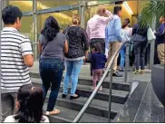  ?? / AP - Amy Taxin ?? In this photo from June 28, people line up outside the building that houses the immigratio­n courts in Los Angeles.