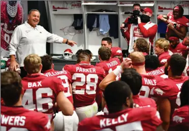  ?? (University of Arkansas/Walt Beazley) ?? Arkansas Coach Sam Pittman addresses his players in the locker room after Saturday’s victory over Ole Miss at Reynolds Razorbacks Stadium in Fayettevil­le. At 2-2, the Razorbacks are one of the surprises in the SEC.