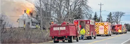  ?? JAMES VAUGHAN PHOTO ?? Firefighte­rs from several department­s on the scene of an April 12 fire in Wellington, Yarmouth County.