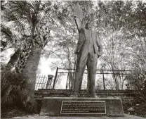  ?? David J. Phillip / Associated Press ?? A statue in Galveston depicts a man holding the state law that made Juneteenth a holiday. As recently as 2010, textbooks in Texas left out slavery as a central cause of the Civil War.