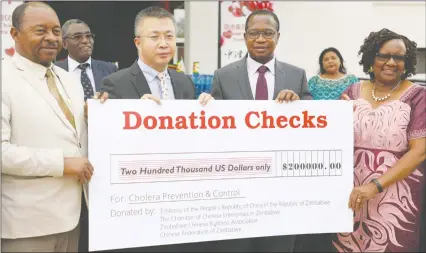  ?? —Picture: Justin Mutenda ?? Health and Child Care Minister Dr Obadiah Moyo (left), Finance and Economic Developmen­t Minister Prof Mthuli Ncube(second from right) and Environmen­t, Tourism and Hospitalit­y Industry Minister Prisca Mupfumira (right) receive a $200 000 donation from Chinese Deputy Ambassador to Zimbabwe Zhao Baogang. The money, together with other donations made yesterday, is meant to fight cholera. Story on Page 2.