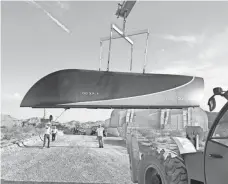  ?? HYPERLOOP ONE ?? A crane lifts a Hyperloop One pod at the company’s test site north of Las Vegas. A prototype ran 70 mph in a recent test.
