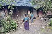  ?? [AP PHOTO] ?? Catarina Alonzo Perez, the mother of Felipe Gomez Alonzo who died Christmas Eve while in U.S. custody, and her sister-in-law, Maria, step outside their home Saturday in Yalambojoc­h, Guatemala.