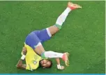  ?? —AFP ?? LUSAIL: Brazil’s forward #10 Neymar falls during the Qatar 2022 World Cup Group G football match between Brazil and Serbia at the Lusail Stadium in Lusail, north of Doha.
