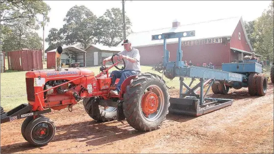  ??  ?? John Marney participat­es in the tractor pull competitio­n held both days at the annual Fall Tractor Show and Pull.