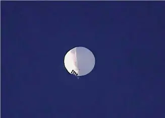  ?? Larry Mayer/Associated Press ?? A high altitude balloon floats over Billings, Mont., on Wednesday. The huge, high-altitude Chinese balloon sailed across the U.S. on Friday, drawing severe Pentagon accusation­s of spying and sending excited or alarmed Americans outside with binoculars. Secretary of State Antony Blinken abruptly canceled a high-stakes Beijing trip aimed at easing U.S.-China tensions.