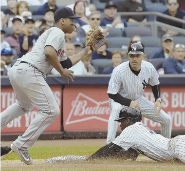  ?? AP PHOTO ?? NOT IN TIME: Red Sox third baseman Rafael Devers gets the throw too late to tag out sliding Yankees shortstop Didi Gregorius during the sixth inning yesterday in New York.