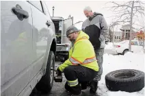  ?? KRIS DUBE TORSTAR ?? CAA Niagara roadside technician Clayton Axnix gets Fonthill resident Patrick Tierney ready for the winter.