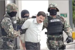  ?? SUSANA GONZALEZ/BLOOMBERG NEWS ?? Drug trafficker Joaquin ‘El Chapo’ Guzman is escorted by Mexican security forces at the airport in Mexico City.