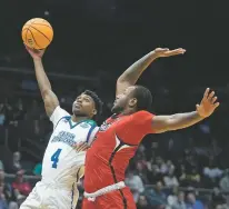  ?? DARRON CUMMINGS/THE ASSOCIATED PRESS ?? Texas A&M Corpus Christi’s Jalen Jackson shoots against Southeast Missouri State’s Phillip Russell on Tuesday during a First Four game in the NCAA Tournament in Dayton, Ohio.