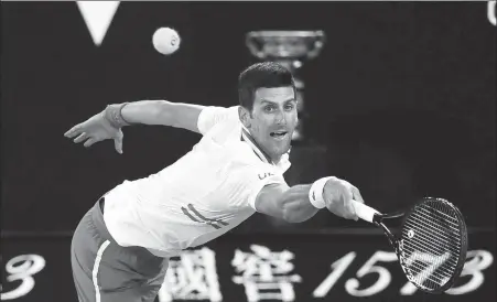  ?? REUTERS ?? Serbia’s Novak Djokovic stretches for a return during the Australian Open final against Russia’s Daniil Medvedev at Melbourne Park on Sunday. Djokovic won 7-5, 6-2, 6-2 to claim a historic ninth title at the Grand Slam tournament.