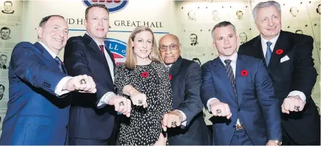  ?? NATHAN DENETTE/THE CANADIAN PRESS ?? The newest members of the Hockey Hall of Fame — from left, Gary Bettman, Martin Brodeur, Jayna Hefford, Willie O’Ree, Martin St. Louis and Alexander Yakushev — show off their rings following the induction ceremony Monday in Toronto.