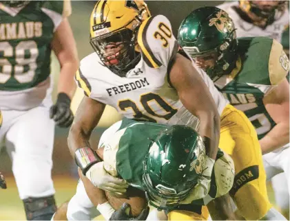  ?? THE MORNING CALL DAVID GARRETT/SPECIAL TO ?? Freedom’s Kyle Johnson brings down Emmaus’ Tylik Jarvis Thursday in a District 11 6A semifinal game at Emmaus High School.