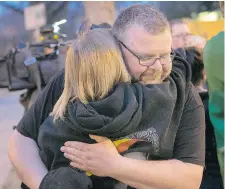  ?? RICHARD MARJAN/The StarPhoeni­x ?? Murder victim Dorothy Woods’s brother, Lawrence Carter, gets a hug outside the courthouse after a jury found David Woods guilty of the firstdegre­e murder of his wife, Dorothy, on Thursday in Saskatoon.