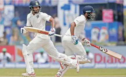  ??  ?? India's cricketers Shikhar Dhawan, left, and Cheteshwar Pujara run between wickets during day one of the first Test against Sri Lanka on Wednesday. (Reuters)