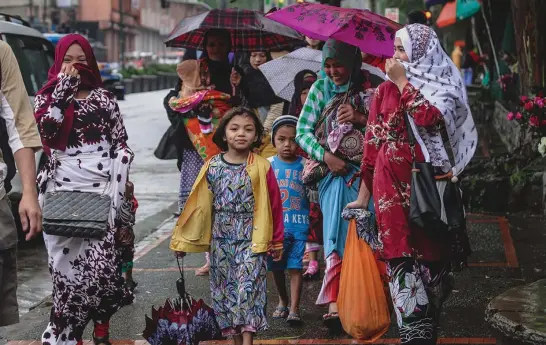  ?? Photo by Jean Cortes ?? ISLAM HOLIDAY. Muslim women in Baguio City get back to their daily grind following an early morning prayer celebratin­g the "Festival of Sacrifice" or Eid al-Adha, the second of two Islamic holidays celebrated worldwide each year.