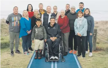  ?? ?? Community sponsors of the Accessible Beach Mats initiative. Back row L-R: David Hayes, Julie Hayes, Mel Gearon, Barb Young, Bill Young, Gary Always, Jessica Harris, Marion Gattung, Demian Dunlop, Theresa Gattung, Peter Church, Trudi Gatland, Cindy Clare. Front row L-R: Tai MacCalman, Dave MacCalman. PHOTO: Cassandra Sharp Photograph­y.