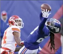  ?? BILL KOSTROUN — THE ASSOCIATED PRESS ?? Giants cornerback Janoris Jenkins, right, intercepts a pass intended for Chiefs wide receiver Demarcus Robinson on Sunday.