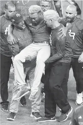  ?? ERIC ESPADA GETTY IMAGES ?? Edwin Diaz is helped off the field after suffering an injury during an on-field celebratio­n for Puerto Rico’s victory Wednesday night in the World Baseball Classic.