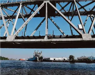  ?? Photos by Kim Brent/Staff photograph­er ?? The Port of Beaumont is seen under the drawbridge as the “Fishing for History” cast and crew pass beneath it aboard the Ivory Bill while filming an episode about shipwrecks found in the waters.