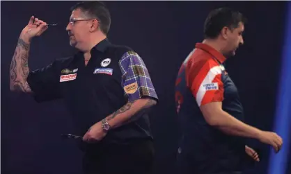  ?? Photograph: Luke Walker/Getty Images ?? Gary Anderson in action during his 4-3 third-round victory against Mensur Suljovic. The Scot questioned the Austrian’s variable pace of play.