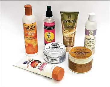  ?? JEROME ADAMSTEIN / LOS ANGELES TIMES ?? Natural hair has hit the mainstream and companies are eager to cash in. Pictured is a sampling of natural hair products including Cantu, Curls, Miss Jessie’s, Au Naturale and SheaMoistu­re.