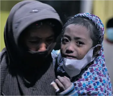  ?? AMAN ROCHMAN/Getty Images ?? A child cries in the evacuation centre in Malang district during the eruption of Mount Kelud volcano in East Java province
on Friday. A spectacula­r volcanic eruption in Indonesia has killed three people and forced mass evacuation­s.