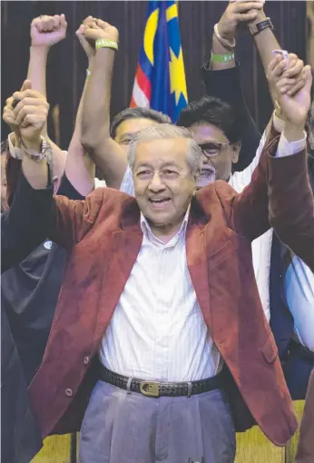  ?? Picture: AP ?? Mahathir Mohamad celebrates his election win with supporters at a hotel in Kuala Lumpur. His victory ends the 60-year rule of the National Front.