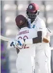  ?? Photo / AP ?? West Indies captain Jason Holder hugs team-mate John Campbell after they completed the test win over England.