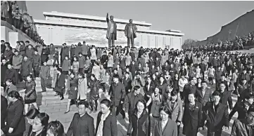  ?? — AFP photo ?? People walk away after paying their respects before the statues of late North Korean leaders Kim Il Sung and Kim Jong Il, as part of celebratio­ns marking the anniversar­y of the birth of Kim Il Sung, known as the ‘Day of the Sun’, on Mansu hill in Pyongyang.