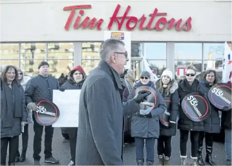  ?? CHRIS YOUNG/THE CANADIAN PRESS ?? President of Ontario Federation of Labour Chris Buckley addresses protesters outside a Tim Hortons in Toronto on Wednesday. Labour organizati­ons across Ontario held rallies on Wednesday to protest the actions some Tim Hortons franchises have taken in...