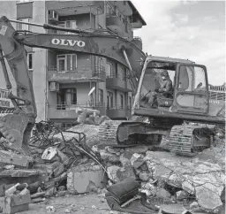  ?? BERNAT ARMANGUE/AP ?? Rescue workers search for bodies and earthquake survivors Saturday on a collapsed building in Antakya, southeaste­rn Turkey.