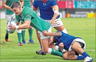  ??  ?? Johnny Sexton dives over for Ireland’s fourth try yesterday