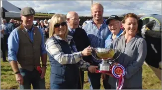  ?? ?? CHAMPION OF champions presentati­on: Mrs Liz Kennedy receiving the rosette with father-inlaw, Hugh, behind her and farm manager, Euan Corbett at the back. Andrew Paton, the judge is in the centre and on the left is Alastair McClymont, donor of the new Walston Trophy, and his finance, Lorna, presenting the trophy