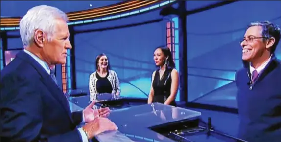  ??  ?? Alex Trebek talks to the contestant­s on the TV show Jeopardy right competed on Thursday night. after Final Jeopardy. Rebecca Zoshak, far left, a Great Valley High School graduate,