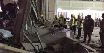  ?? THE ASSOCIATED PRESS ?? Saudi civil defence personnel inspect the damage at the Grand Mosque in Mecca after a crane collapsed Friday.