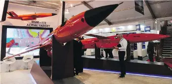  ?? MARY TURNER/BLOOMBERG ?? An attendee looks at a life-size model of a BQM-167A remote-controlled aerial target drone, used by the U.S. air force, at the Farnboroug­h air show in Farnboroug­h, U.K., on Tuesday.