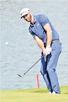  ?? — AFP photo ?? Dustin Johnson of the US chips a ball onto the green during the third round of the WGCHSBC Champions at the Sheshan Internatio­nal golf club in Shanghai on October 28, 2017.