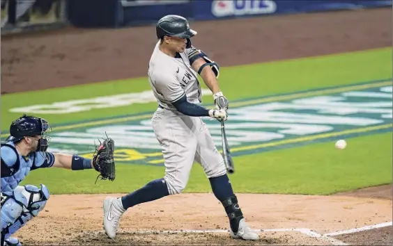  ?? Gregory Bull / Associated Press ?? The Yankees’ Giancarlo Stanton hits a three-run home run to score Luke Voit and Aaron Hicks during the fourth inning in Game 2 of the ALDS against the Tampa Bay Rays on Tuesday night. The game ended too late for this edition. For a complete story go to timesunion.com/sports.