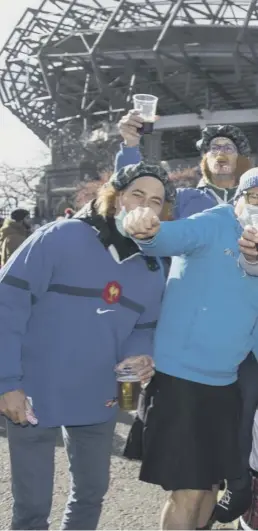  ??  ?? French rugby supporters didn’t let their face masks get in the way of a pre-match pint before the Six Nations meeting with Scotland at Murrayfiel­d yesterday