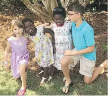  ?? JOSH CHRISTIAN/ THE ASSOCIATED PRESS ?? The four children of Josh and Laura Beth Christian: Emme Sue, 8, left, Tula, 4; Lola, 6, and Camden, 11. Tula and Lola were adopted from Uganda after a long delay and extra cost.